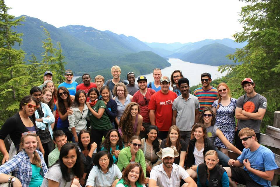 Large group of Corps Members standing together at a lookout spot over a lake and mountains