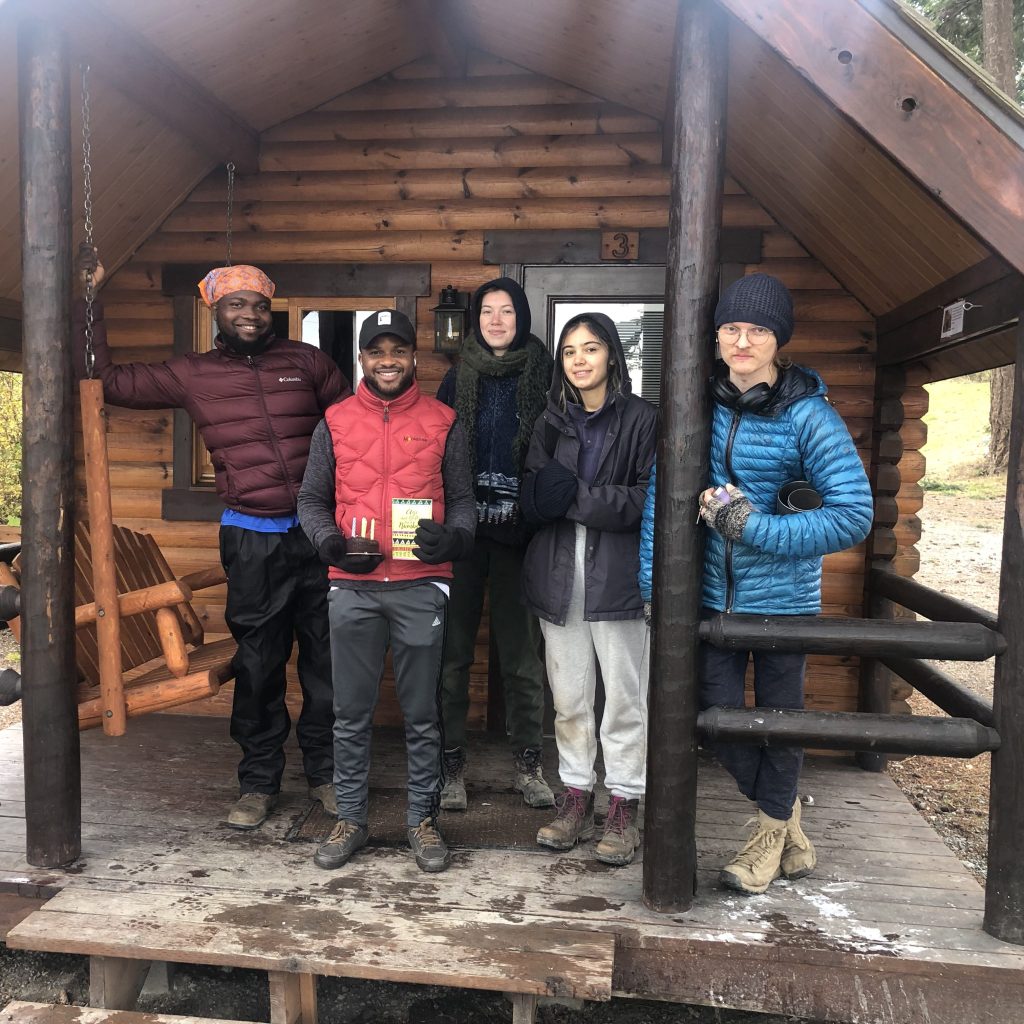 EarthCorps International Corps on a cabin porch with EarthCorps Staff Member.