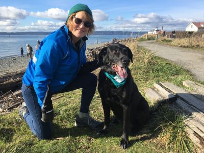 Picture of Betsey with her dog wearing an EarthCorps bandana