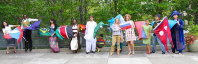 International alumni holding flags from their countries.