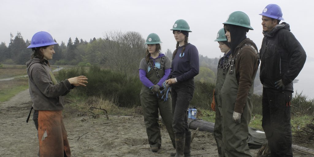 Project manager, Madeline de Mahy, talking with a small group of Corps Members. 