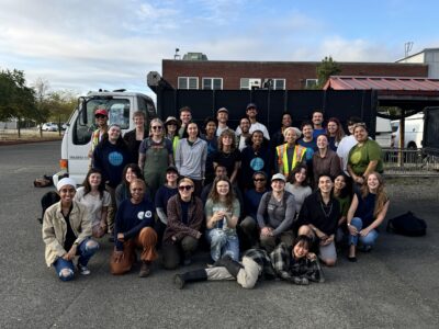 EarthCorps corps members and staff in front of Isuzu Dump Truck