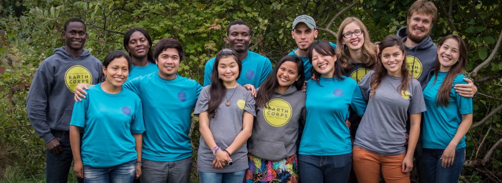 Group of smiling international Corps Members, wearing EarthCorps t-shirts and sweatshirts.