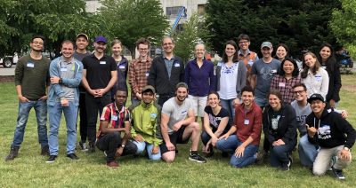 EarthCorps staff and international Corps Members smiling in a group together.