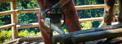 Person sawing through a piece of wood.