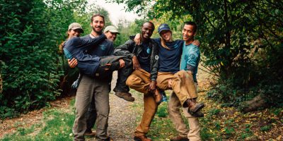 Corps Members smiling, embracing and holding each other.