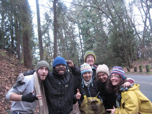 Mila's crew huddling outside together, smiling at the camera