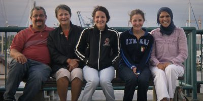 Volunteer specialist, Natalie Izzo, and her family with international Corps Member, Hala, who they hosted.